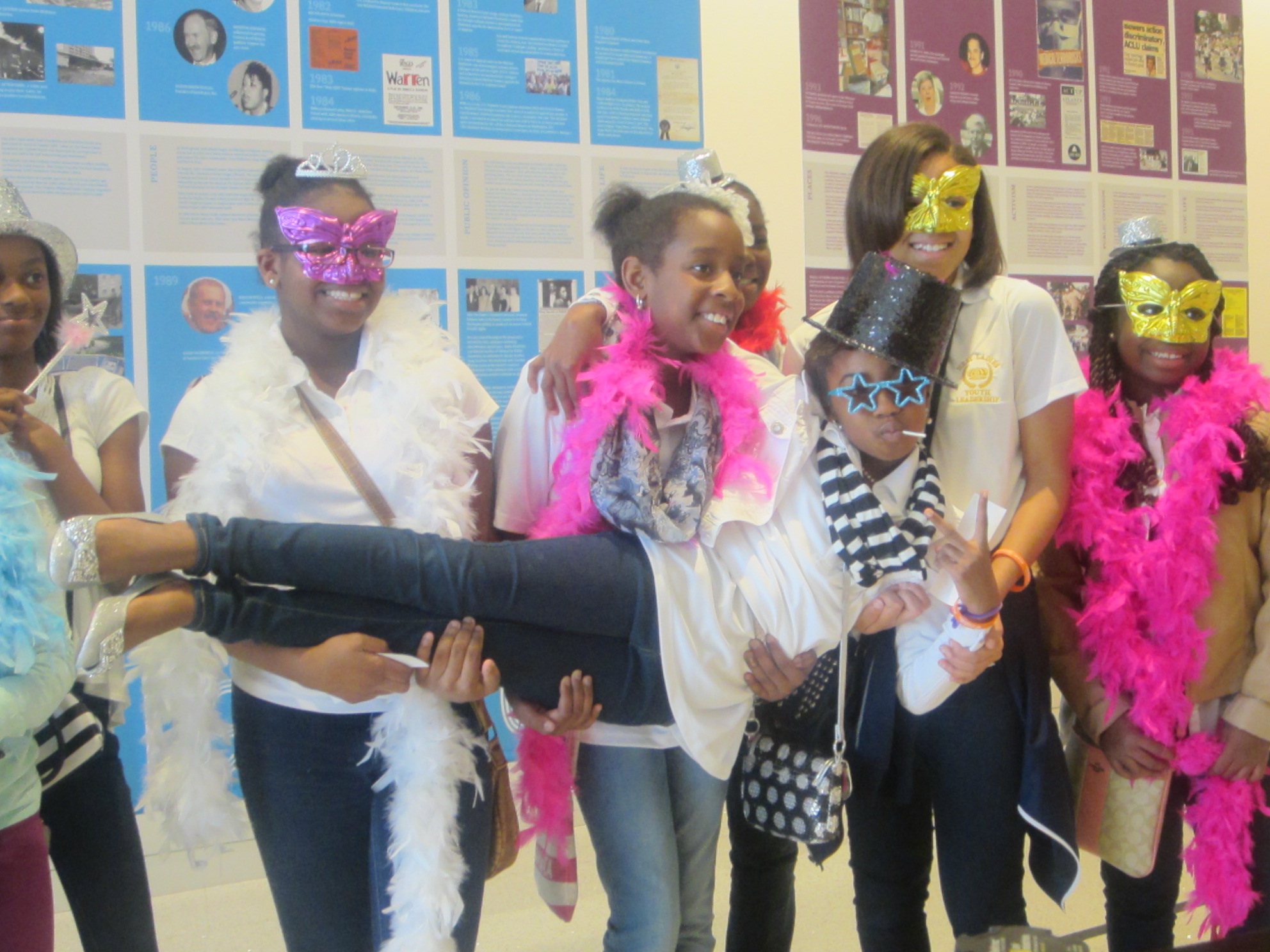 International Day of the Girl attendees pose in there best get ups outside the photo booth.