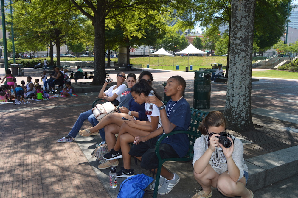 The VMCers and their volunteer mentors take a break to hydrate and hang out in Olympic Centennial Park during an expedition to attain footage for their project on teen pregnancy.